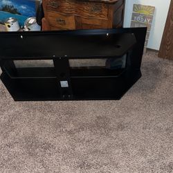 Black TV stand with glass shelves