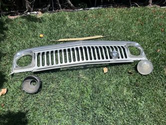 Jeep razor grill with medallion, trim rings and buckets. Also hood filler piece.