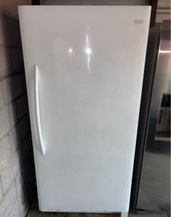 White frigidaire standing freezer