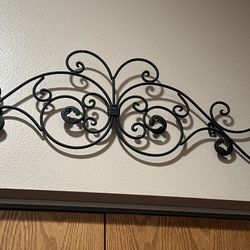 Wall hanging Metal Black Rod Iron from Hobby Lobby. Can be spray painted any color. Measures 12”Tx36”L 