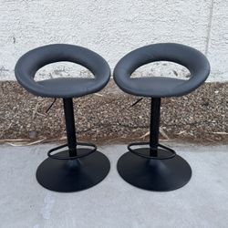 Two Gray Leather Barstools