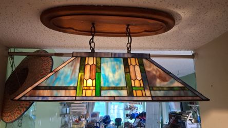 stained glass rectangular billiard or pool table pendant light fixture with blue, green, and amber geometric panels.