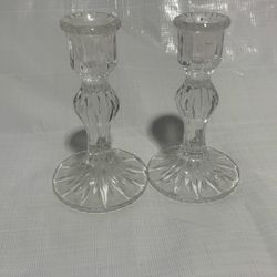 A pair of glass candle holders