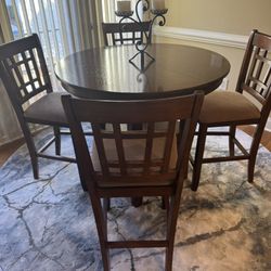 Counter Height Dinning Set. Dimensions: 36”-60”L x 36”W x 60”H.