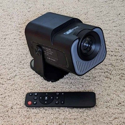 4K portable indoor or outdoor smart movie projector with 30"-150" view, 180 degree rotation & remote control