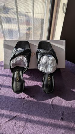 Katy Perry The Tooliped Twisted Sandal in black faux leather.