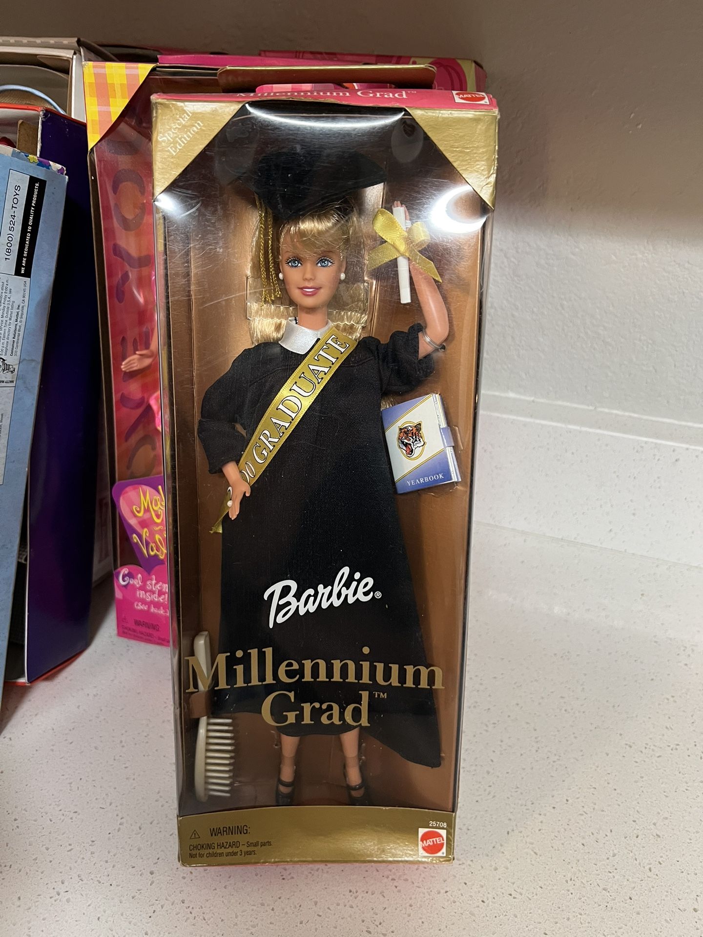 Millennium Grad Barbie Doll, a Special Edition release from Mattel in 2000. The doll features a black graduation gown and cap with gold accents. Acc