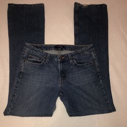 Levi’s 518 Superlow size 9 long jeans. The bottom of one pant leg shows some wear