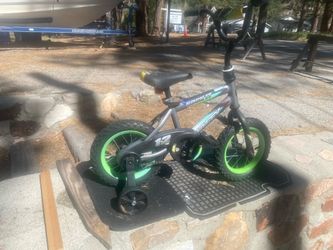 Boys BMX Huffy, 12 inch wheels, with training, wheels, ridden one time.