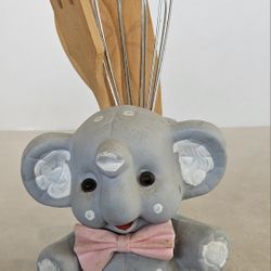 Gray Elephant figurine that is being used as a utensil holder.