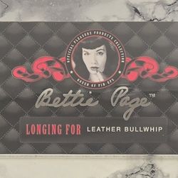 NEW - SEALED - Bettie Page Longing For Leather Bullwhip (HAS DAMAGED PACKAGING)
