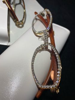 One (1) Millionaire Celebrity French Unisex wooden frame with sparkling lab, diamond ice trim. Comes with a white protective case for secure storage. 