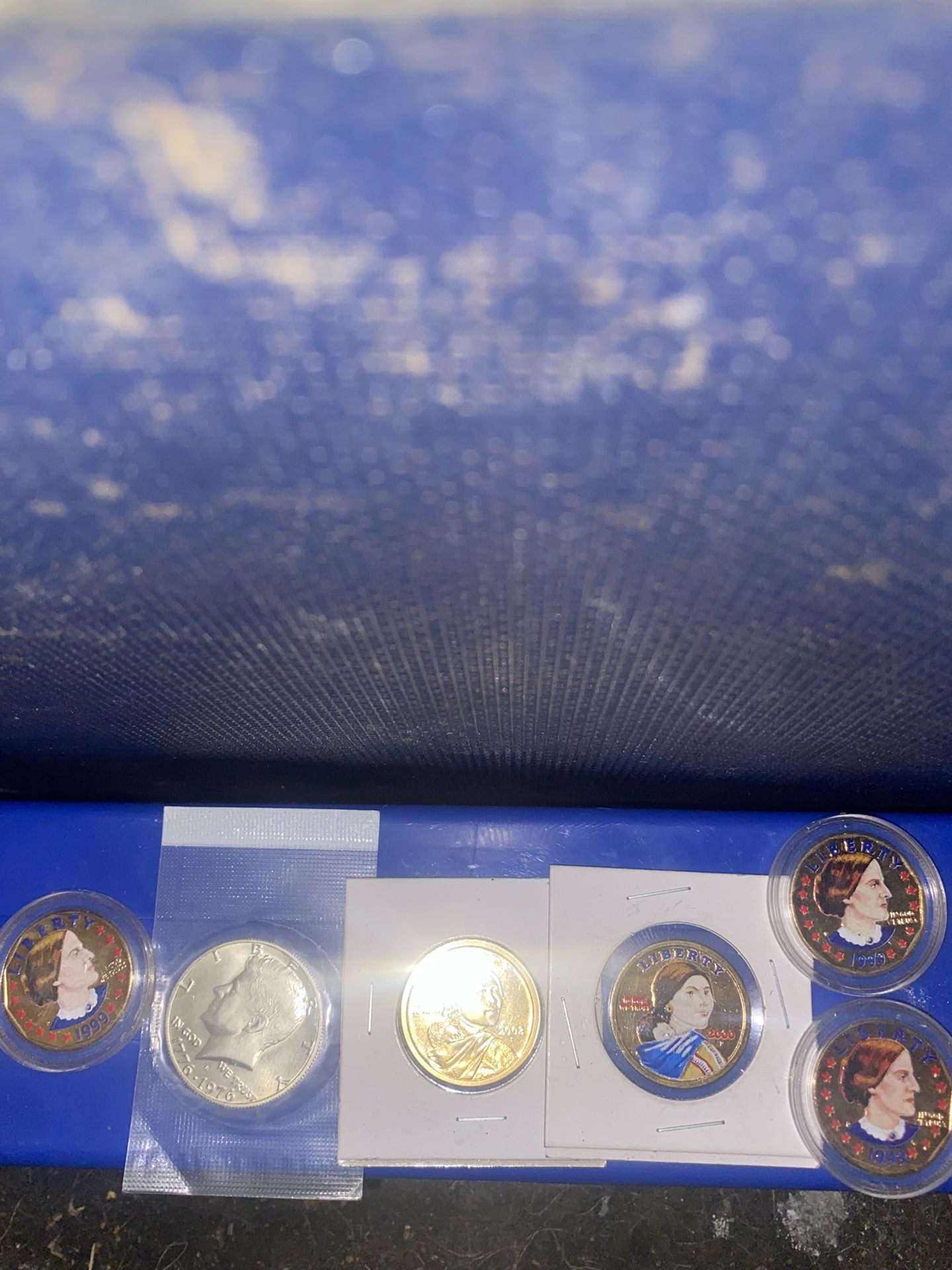 Three colorized Susan B Anthony one colorized one dollar and one proof Silver Me