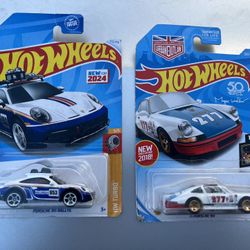 2 Porsche hot wheel cars in the packages