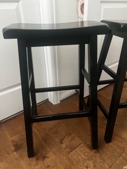 Two matching black barstools