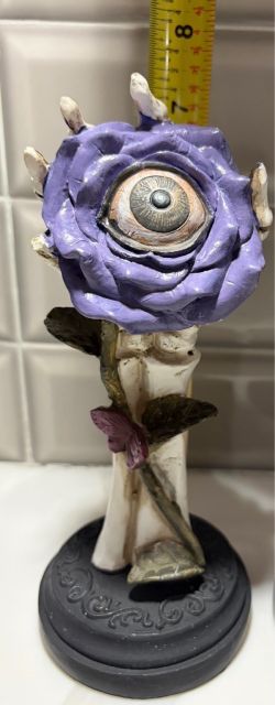 Ashland Michaels Halloween goth skeleton hand holding a purple rose with creepy eye decoration