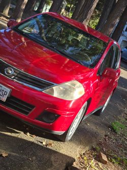 Red Nissan Versa Hatchback