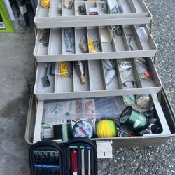 multi-tiered tackle box filled with various fishing gear and accessories