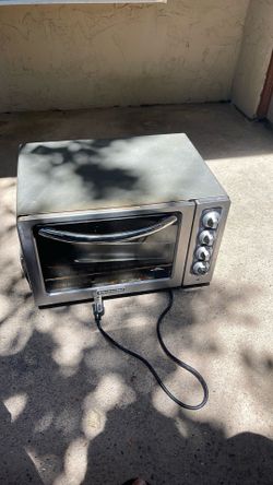 This KitchenAid countertop toaster oven is a stainless steel model that features four rotary control knobs.