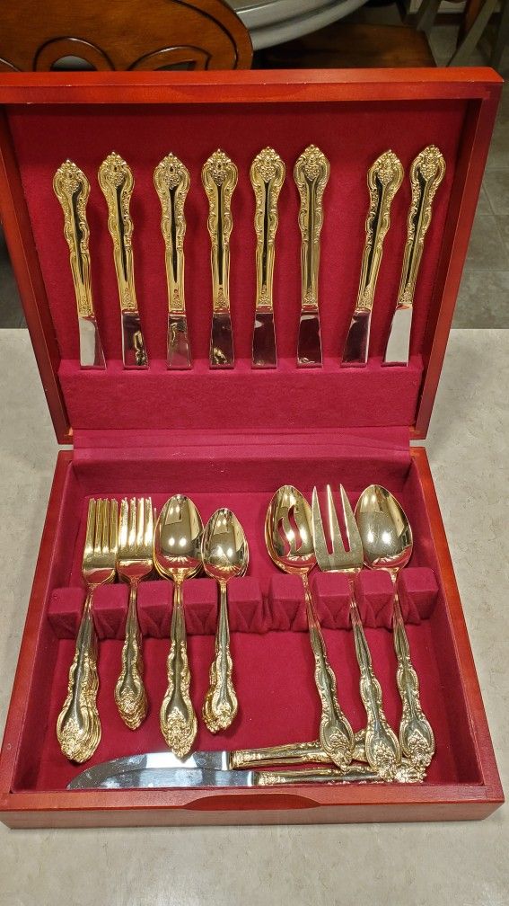 Gold tone International stainless silverware with storage box