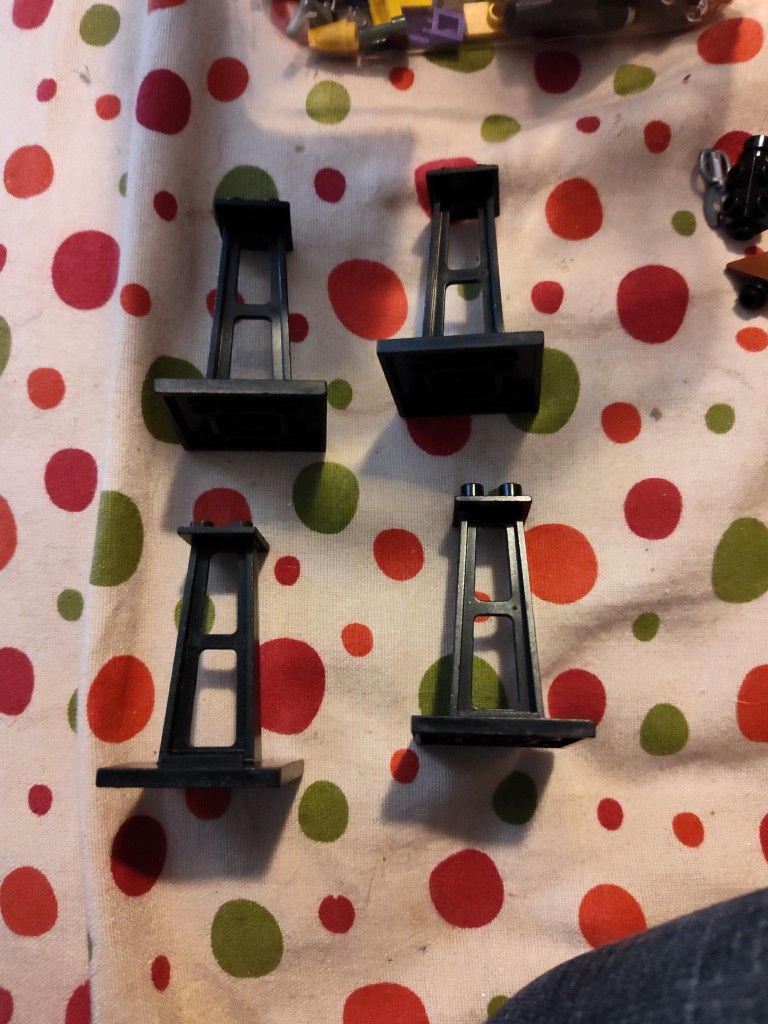 4 Black Lego Stand Pieces