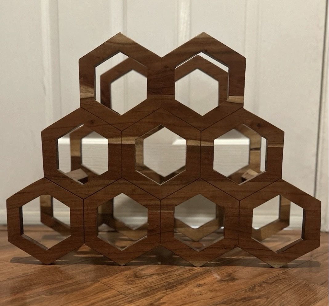 Mid-century modern handmade wooden honeycomb wine rack holds nine bottles