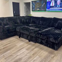 Black Fabric Sectional With Pull Out Bed And Storage. Brand New.