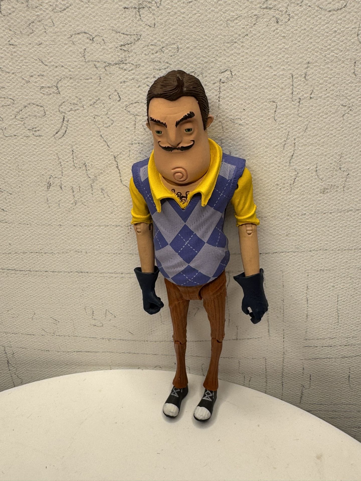 This is a figurine of Theodore Peterson, the neighbor from the game Hello Neighbor, produced by McFarlane Toys.