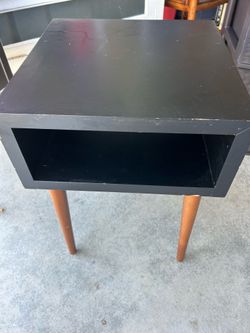 Mid - Century Modern nightstand with tapered legs