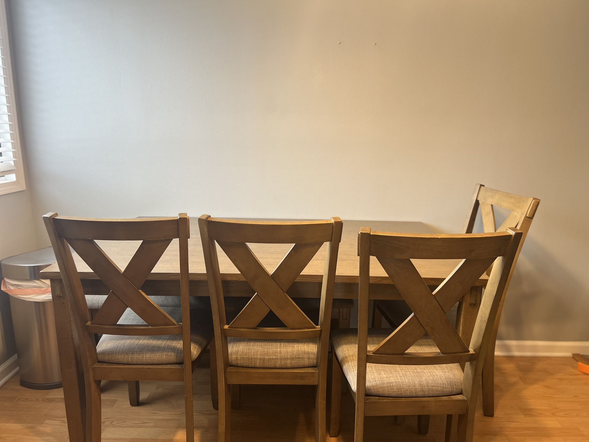 Dining room table with four chairs and bench