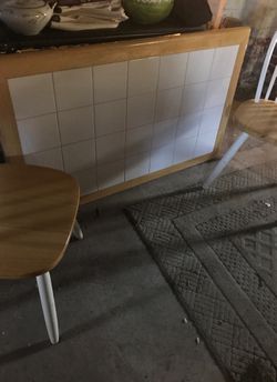 Small white tile table with two chairs