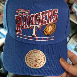 Texas Rangers snapback baseball cap wfeaturing a retro-style embroidered graphic on a royal blue crown. Based on the visible sticker, this is a Mitc