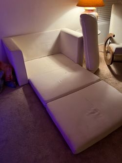 Two seater couch with pull out bed and shelves