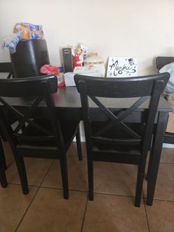 It's a black wooden table and chairs