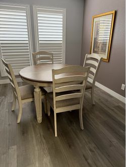Farmhouse Dining table and 4 ladder-back chairs. 48.88 inches wide round , 71.88 inches wide oval with leaf.  30.25 inches  high