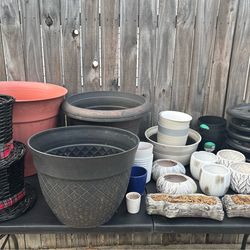 Assorted size Potts  planters, rolling plant stands, etc stands