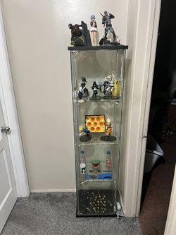 Display Case With Figures And Collectibles