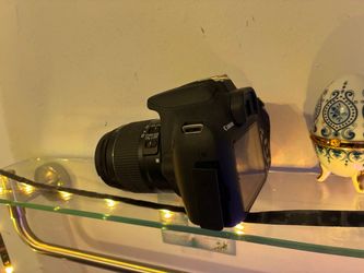 This is a Canon EOS 2000D, an entry-level digital single-lens reflex (DSLR) camera. It features a 24.1-megapixel APS-C sensor and is also known as the