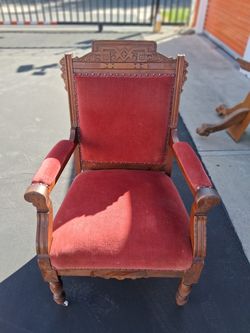antique Victorian Eastlake-style parlor open armchair made of wood with red velvet upholstery