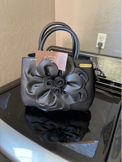 Black vegan leather handle bag is from the L'Artiste