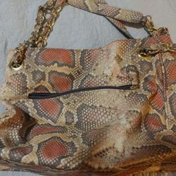 
Snake print handbag with gold chain and printed straps. Lots of pockets and roomy - no tags but UNUSED