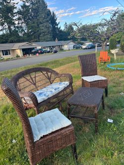 Coach with two chair and table and kitchen