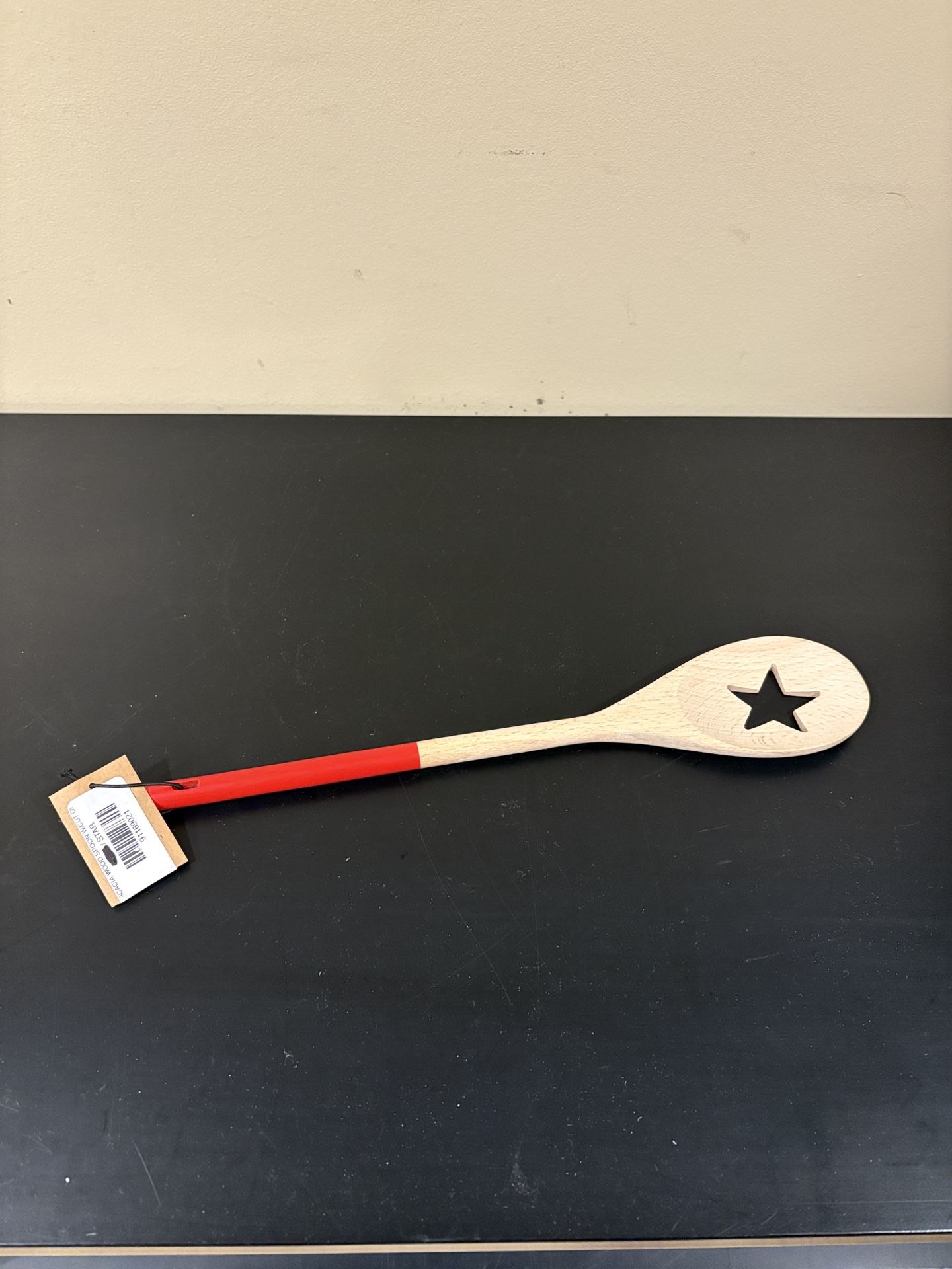 acacia wood spoon with cut oil and a star design