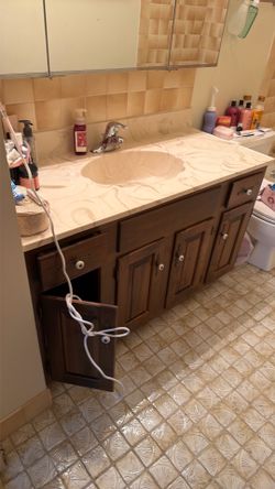 Bathroom mirror and vanity with sink and faucet