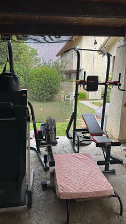 Gym equipment- bench and dip set punching bag, set treadmill and a rower machine