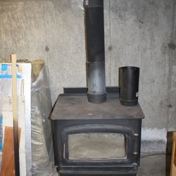 Wood Stove With Interior And Exterior Pipe