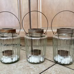 Three outdoor candle holders. 