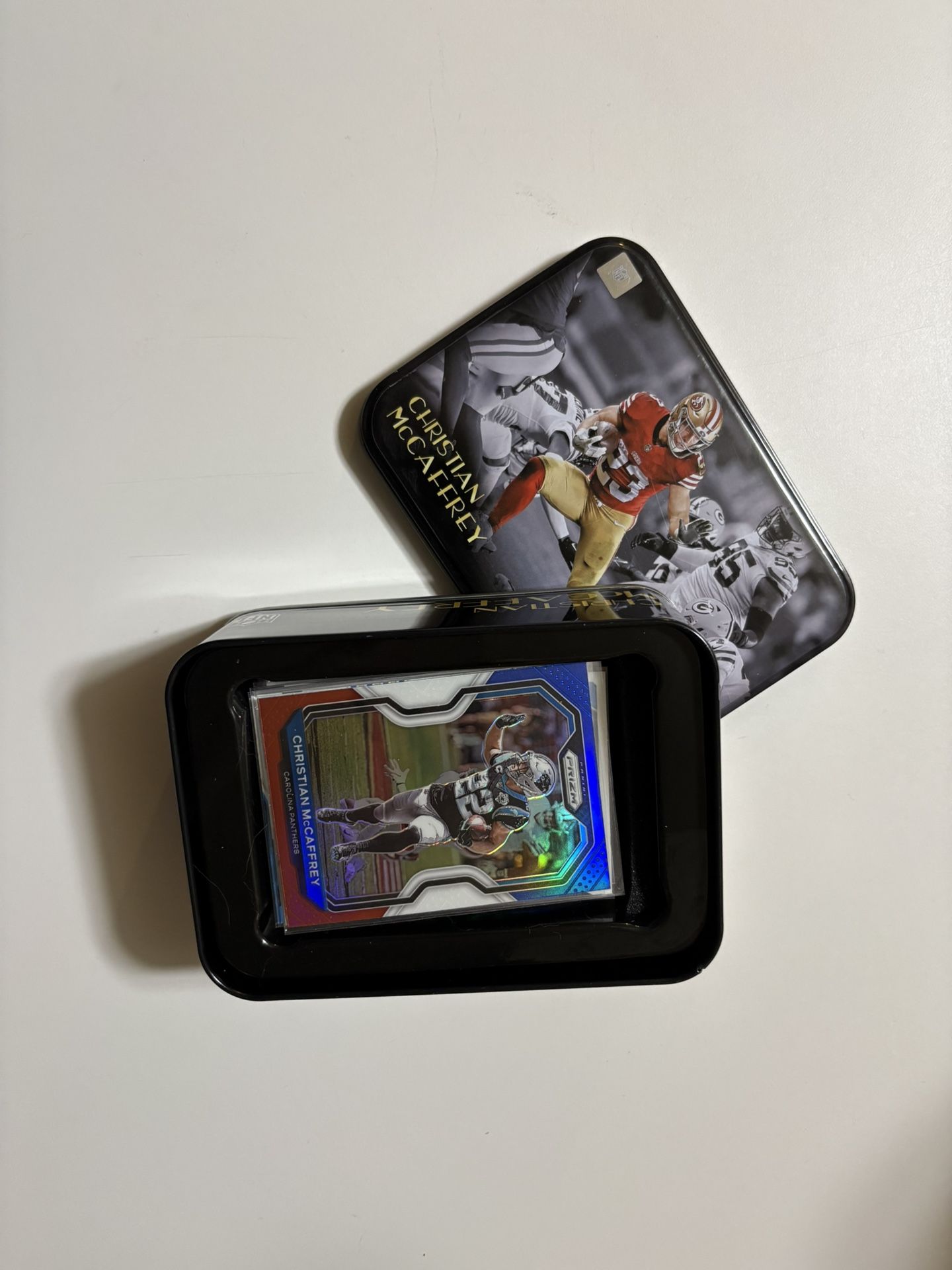 Christian McCaffrey Tin & 23 Various Cards. Rookie, Inserts, Base, Holo And