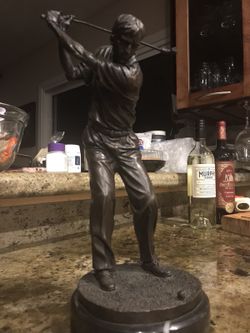 Bronzed golfer on marble base.