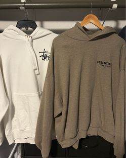 Brown Essentials and white Stussy hoodie